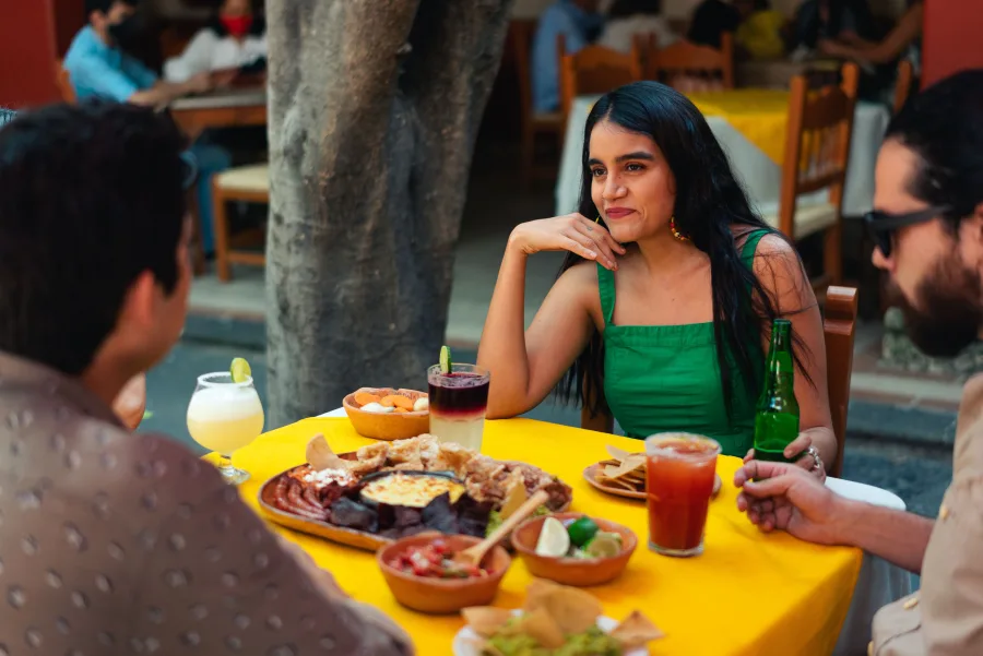 A traveler enjoying a meal at a restaurant while on a trip